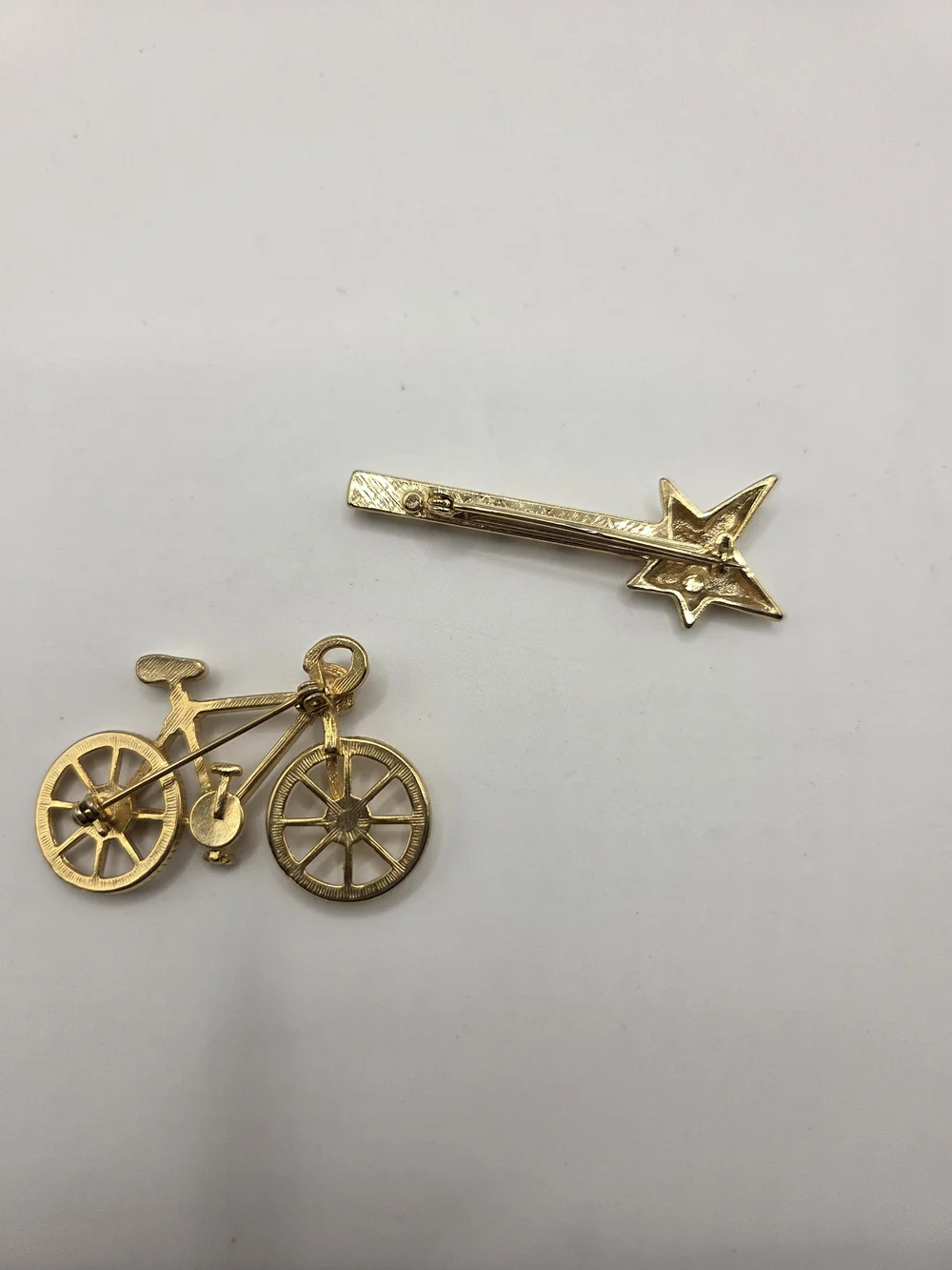 1569. Set Of Two Fun Gold Tone Brooches